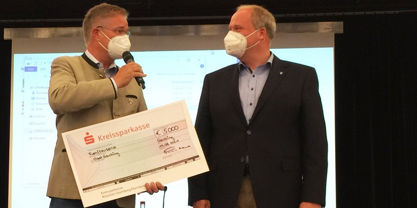 Foto: Landrat Christoph Göbel übergibt den Scheck über die Siegprämie an den Garchinger Bürgermeister Dr. Dietmar Gruchmann